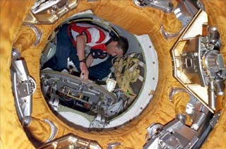 STS-86 commander James Wetherbee opens the hatch on the shuttle side. 